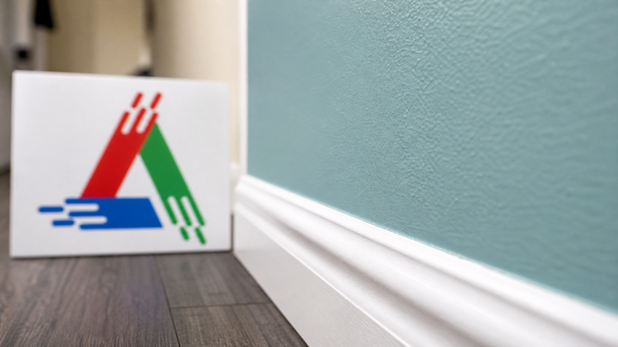 Close-up of a crisp cut-in line where a wall colour meets white trim, showing clean brushwork and even roller texture