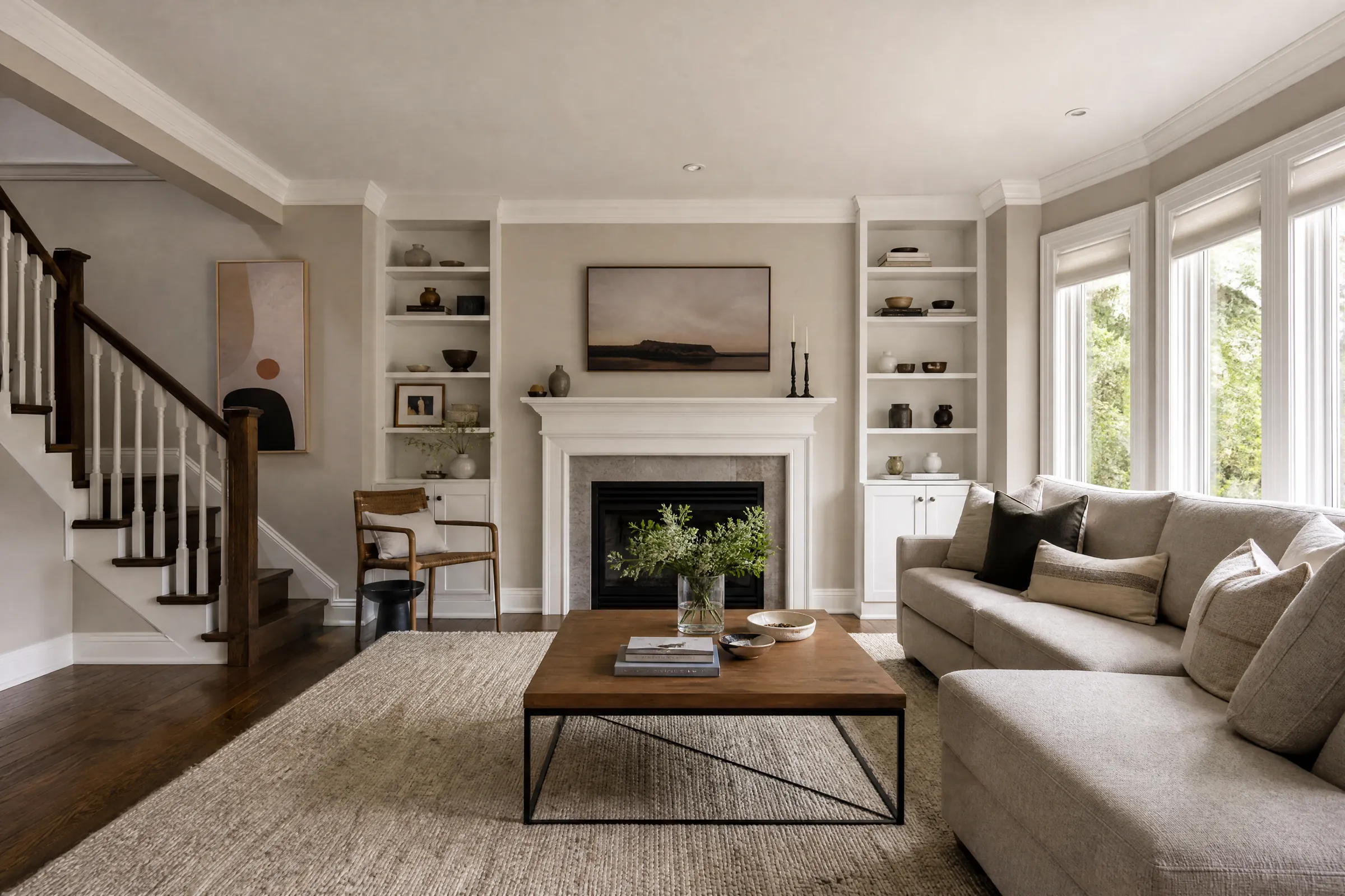 Bright living room freshly painted greige with a white fireplace mantel