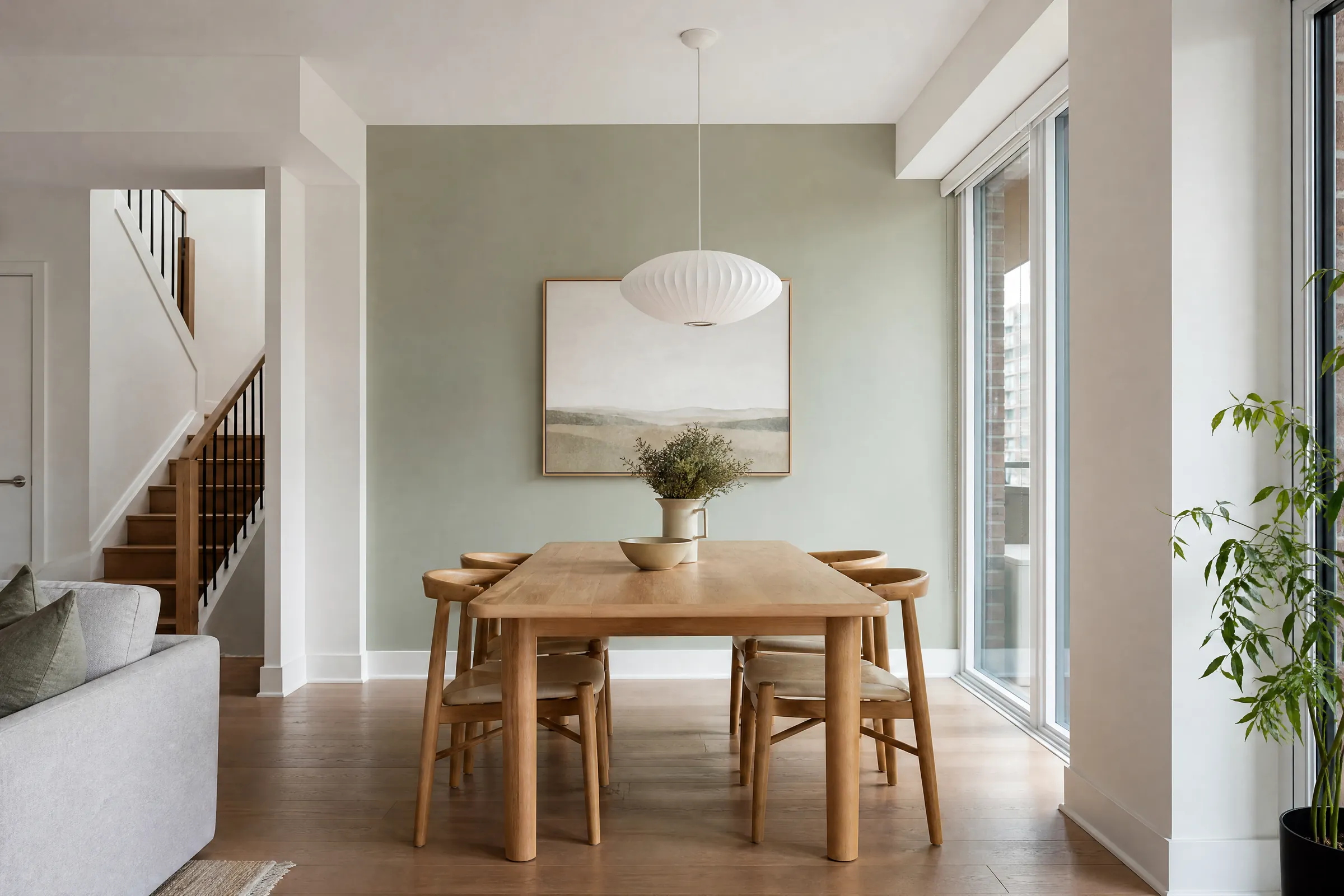 Condo dining area freshly painted white with an oak table