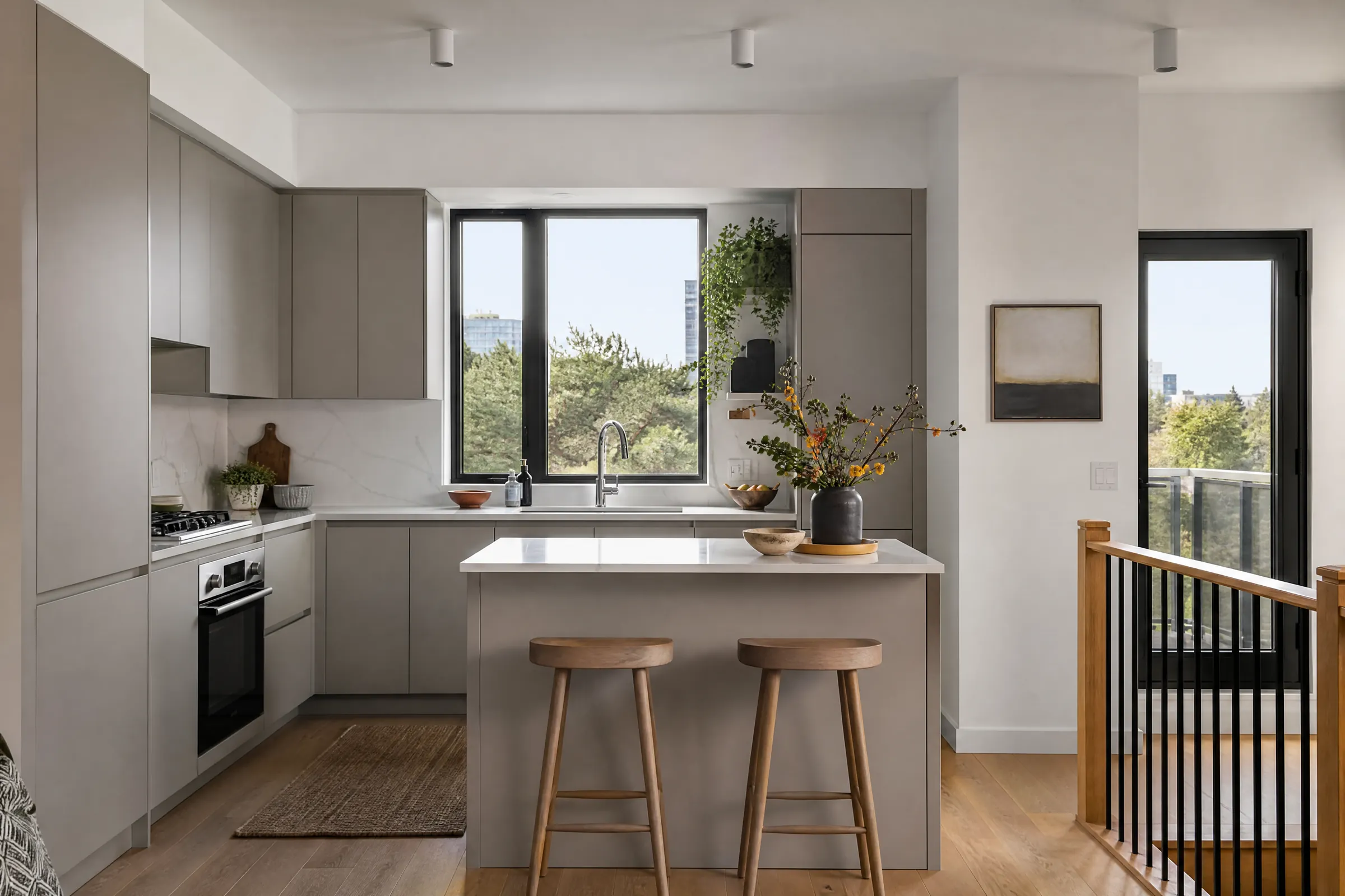Condo kitchen with freshly painted soft grey slab cabinets