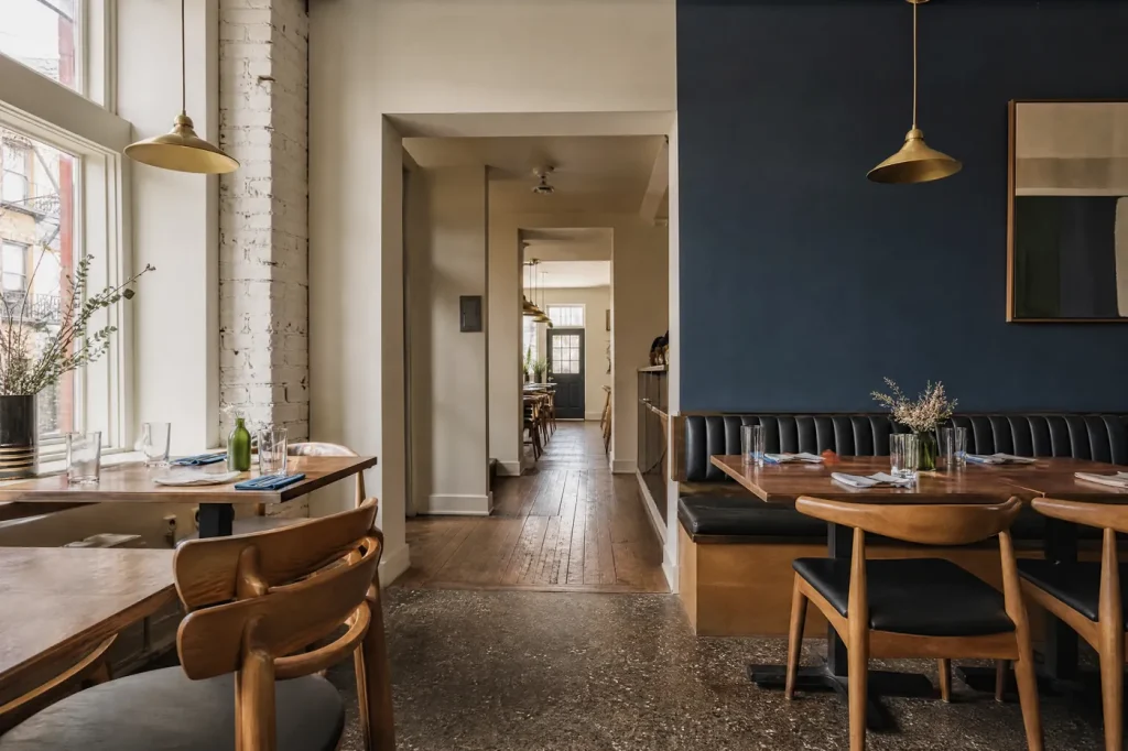 Restaurant dining room freshly painted warm white with a navy wall
