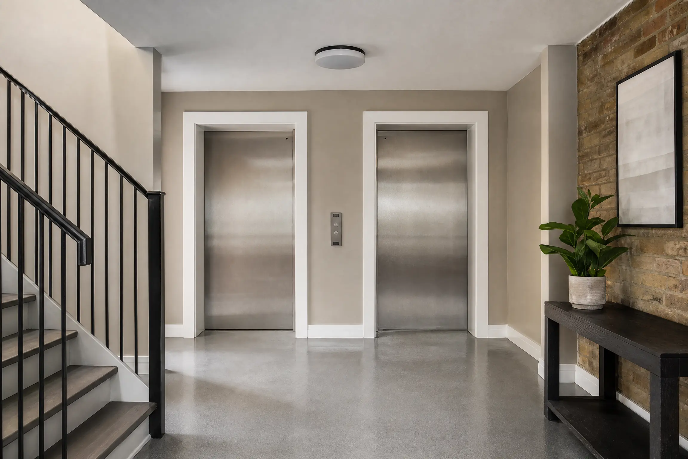 Parking-level elevator lobby freshly painted warm taupe with white door frames
