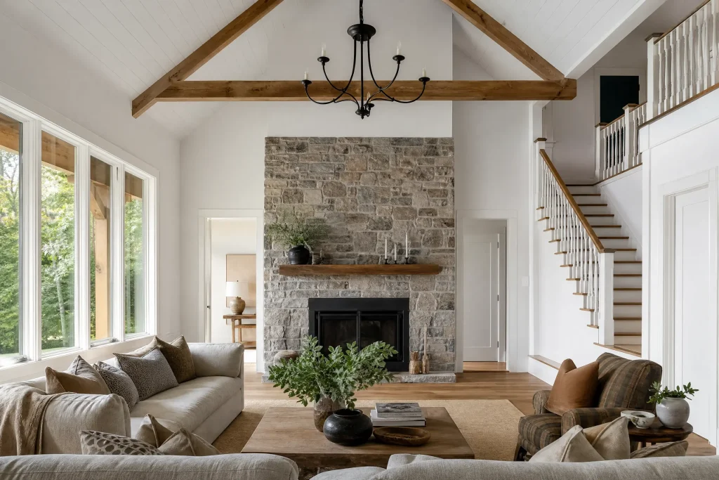 Great room repainted fresh white under a white plank ceiling with wood beams