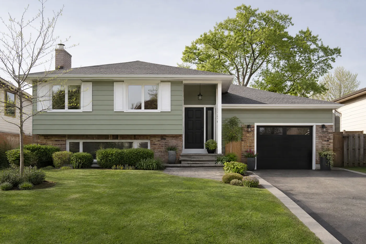 Back-split with aluminum siding freshly painted soft sage