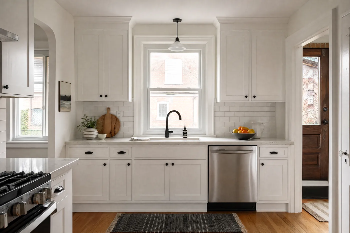 Kitchen with original cabinets freshly painted soft white