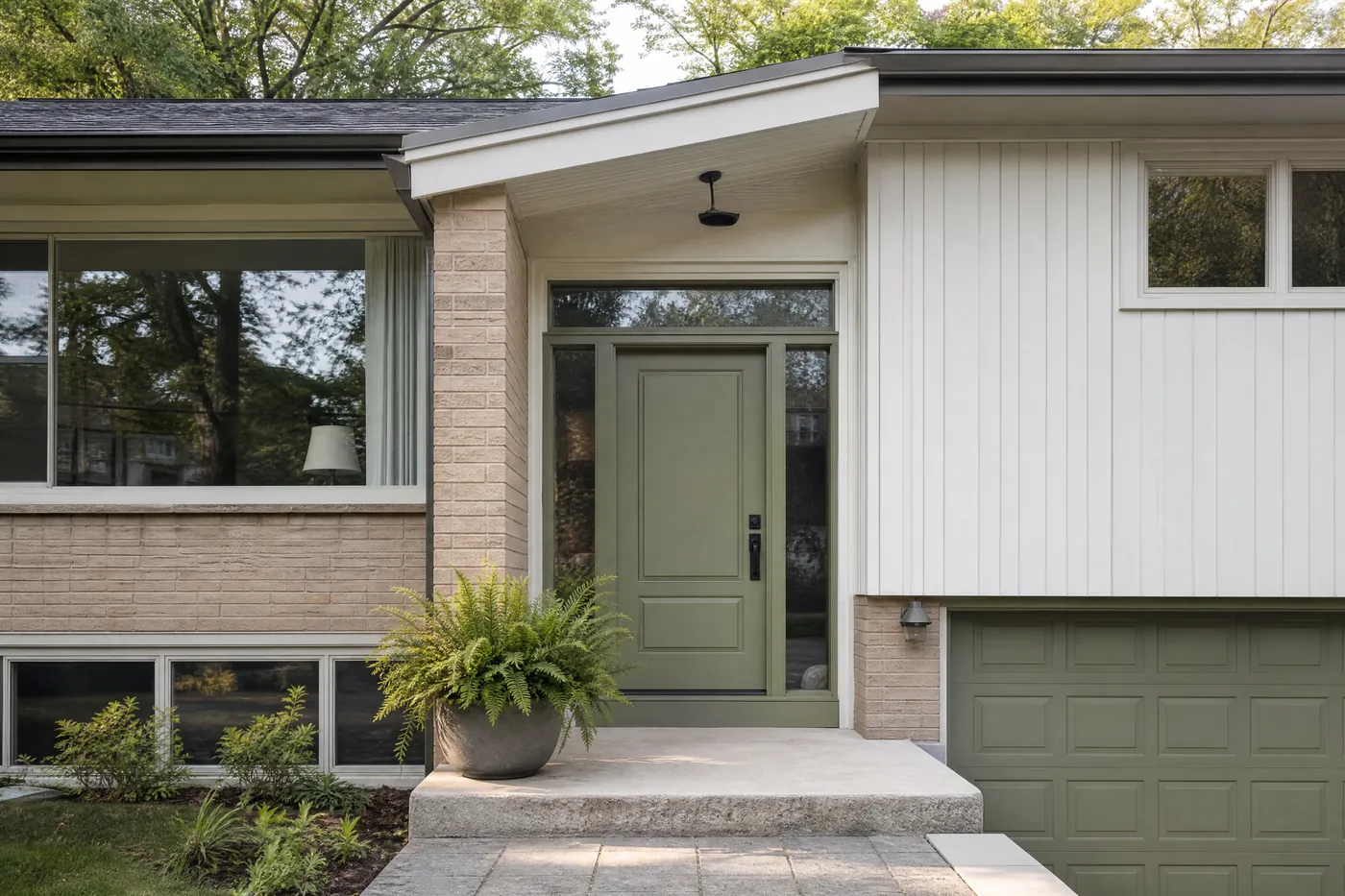 Side-split entrance with a freshly painted sage front door