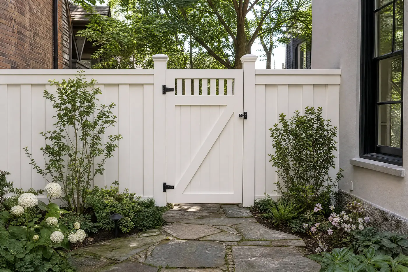 Board-and-batten garden fence freshly painted soft white