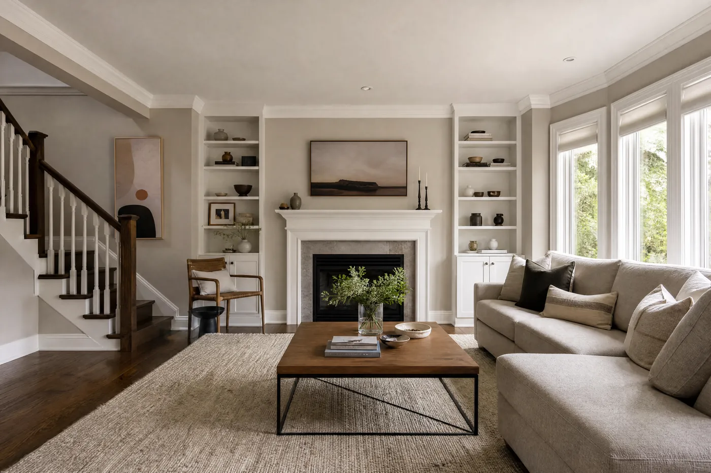 Bright living room freshly painted greige with a white fireplace mantel