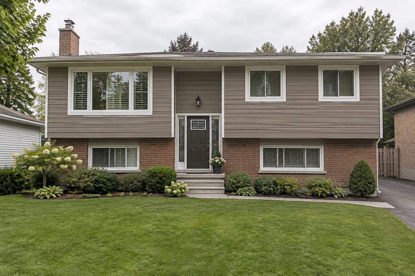 Back-split with aluminum siding repainted warm taupe