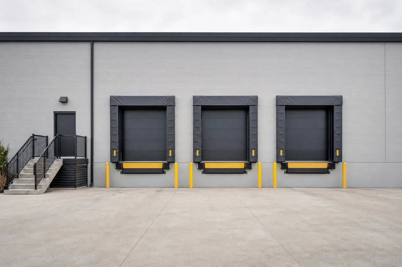 Loading dock wall freshly painted grey with charcoal dock doors