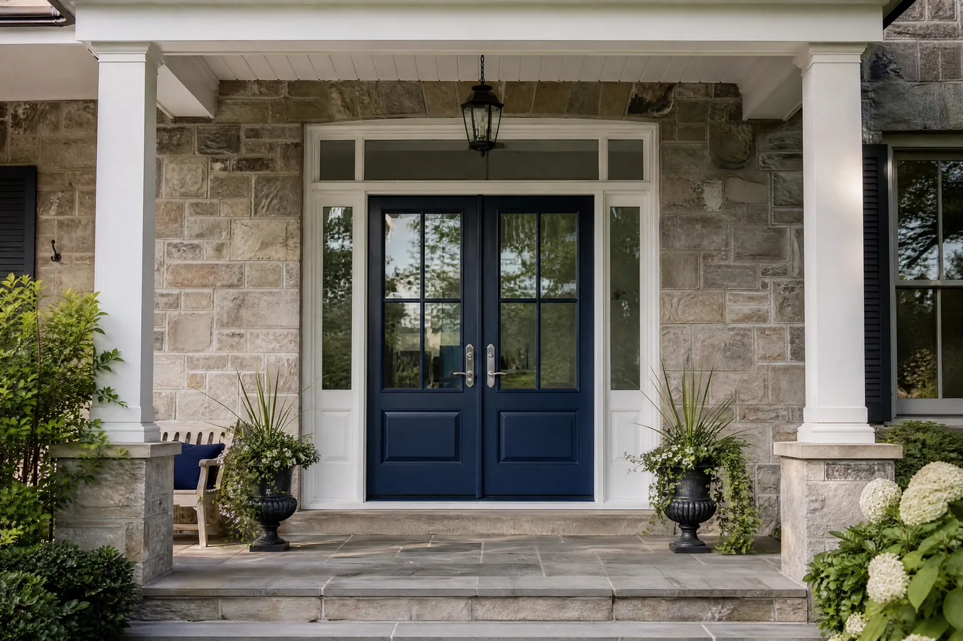 Double front doors freshly painted navy with white sidelights